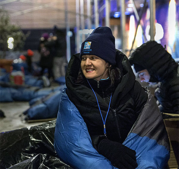 Woman smiling at a Sleep Out event